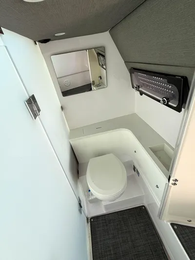  Yacht Photos Pics 2022 Axopar 37 Sun Top boat bathroom with modern fixtures and compact design.