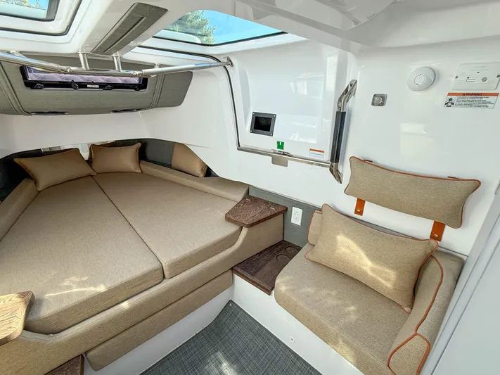  Yacht Photos Pics 2022 Axopar 37 Sun Top cabin interior with beige seating and modern design.
