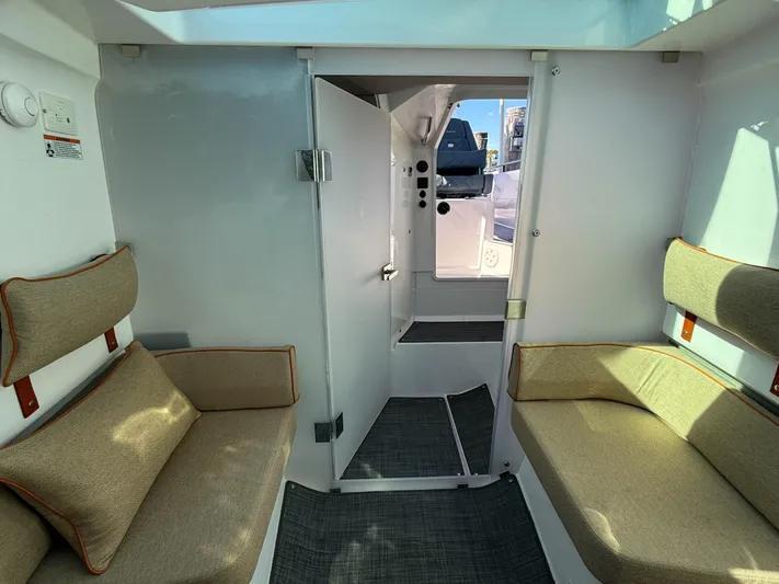  Yacht Photos Pics Interior of 2022 Axopar 37 Sun Top with cozy seating and modern design.