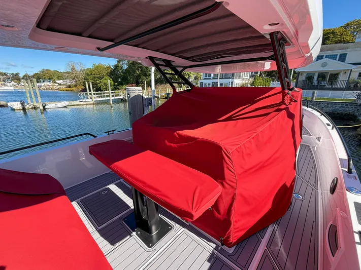  Yacht Photos Pics 2022 Axopar 37 Sun Top boat with red seating cover, docked by the water.