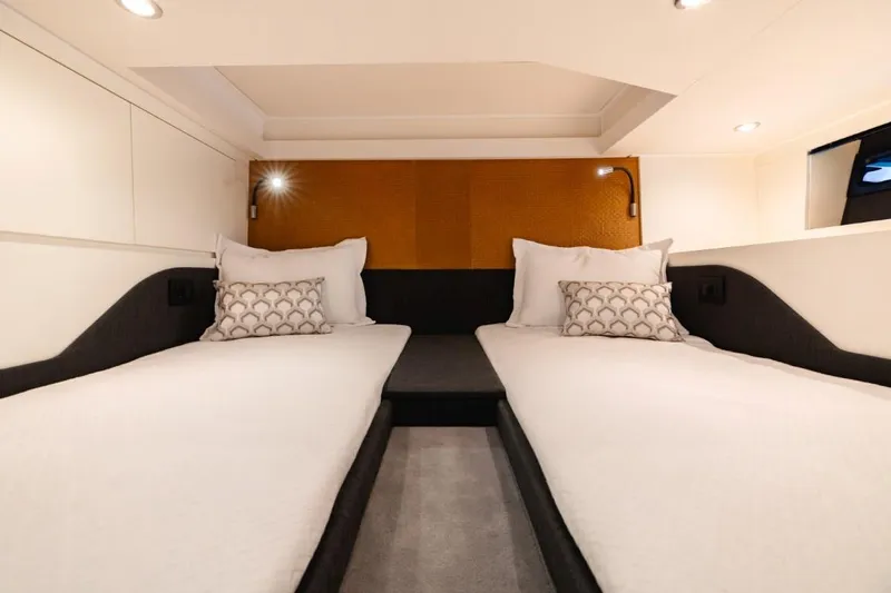  Yacht Photos Pics 2024 Azimut Verve 48 cabin with twin beds, modern design, and ambient lighting.