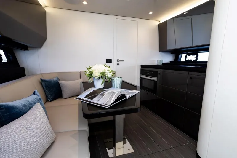  Yacht Photos Pics Luxurious interior of 2024 Azimut Verve 48 yacht with modern kitchen and elegant seating area.