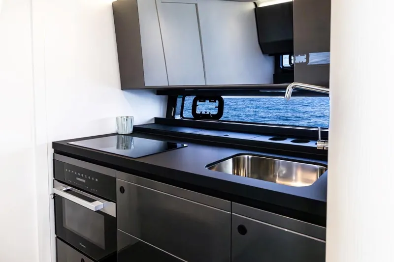  Yacht Photos Pics Modern kitchen interior of 2024 Azimut Verve 48 yacht with sleek design and ocean view.