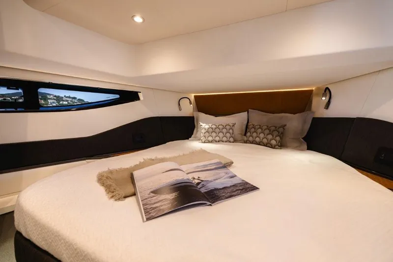  Yacht Photos Pics Luxurious cabin interior of 2024 Azimut Verve 48 yacht with cozy bedding.