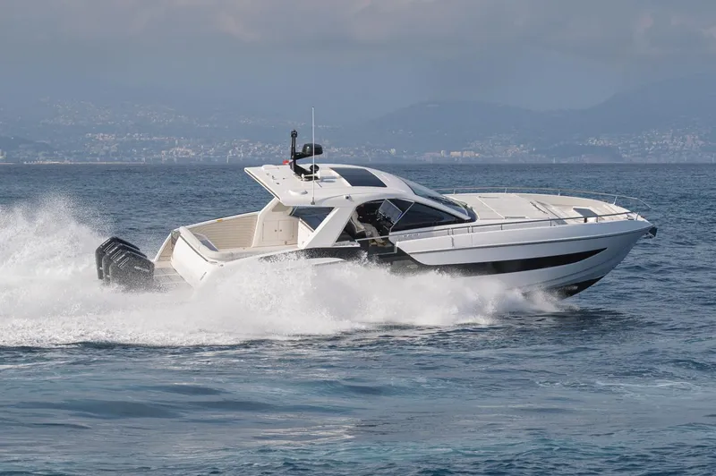  Yacht Photos Pics 2024 Azimut Verve 48 yacht cruising swiftly on open water.