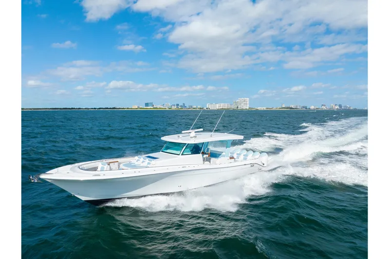  Yacht Photos Pics 2026 HCB 56 Suenos GIX luxury yacht cruising on open water under blue skies.