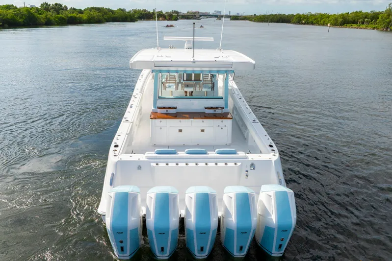  Yacht Photos Pics 2026 HCB 56 Suenos GIX luxury boat with five powerful outboard engines on a serene waterway.