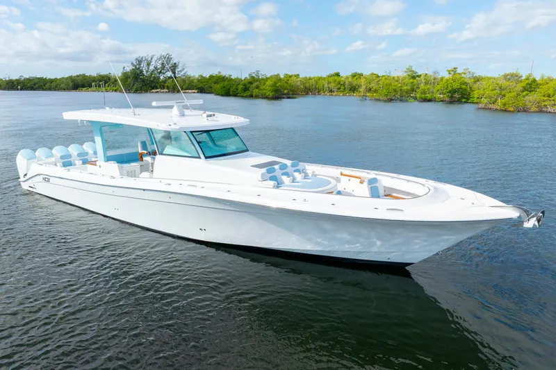  Yacht Photos Pics 2026 HCB 56 Suenos GIX luxury boat cruising on a serene waterway.