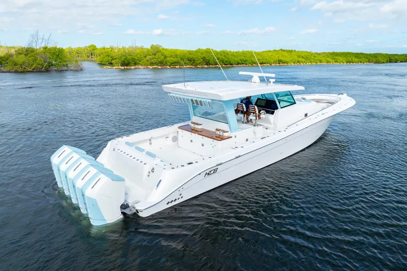  Yacht Photos Pics 2026 HCB 56 Suenos GIX luxury boat cruising on a serene waterway.