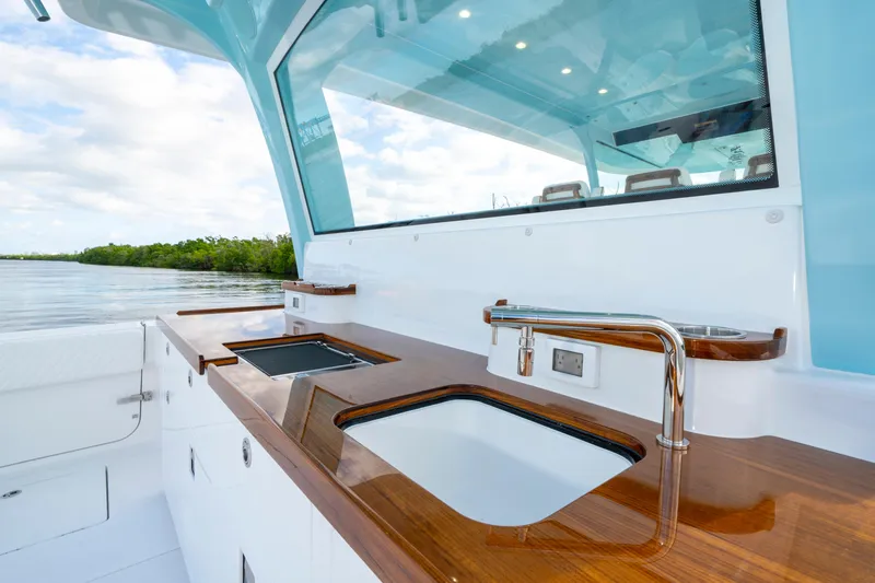  Yacht Photos Pics Luxurious 2026 HCB 56 Suenos GIX yacht with sleek outdoor kitchen and modern amenities.