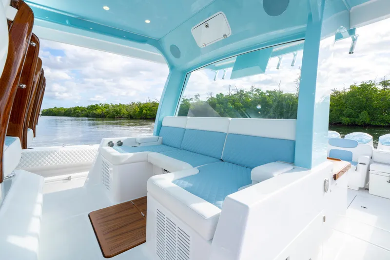  Yacht Photos Pics Luxurious interior of 2026 HCB 56 Suenos GIX yacht with blue seating and scenic water view.