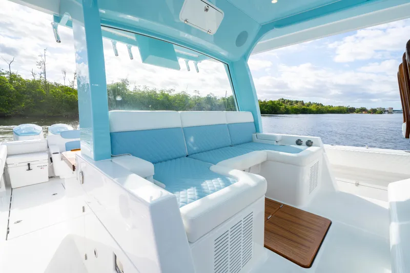  Yacht Photos Pics Luxurious interior of 2026 HCB 56 Suenos GIX boat with blue seating and scenic water view.