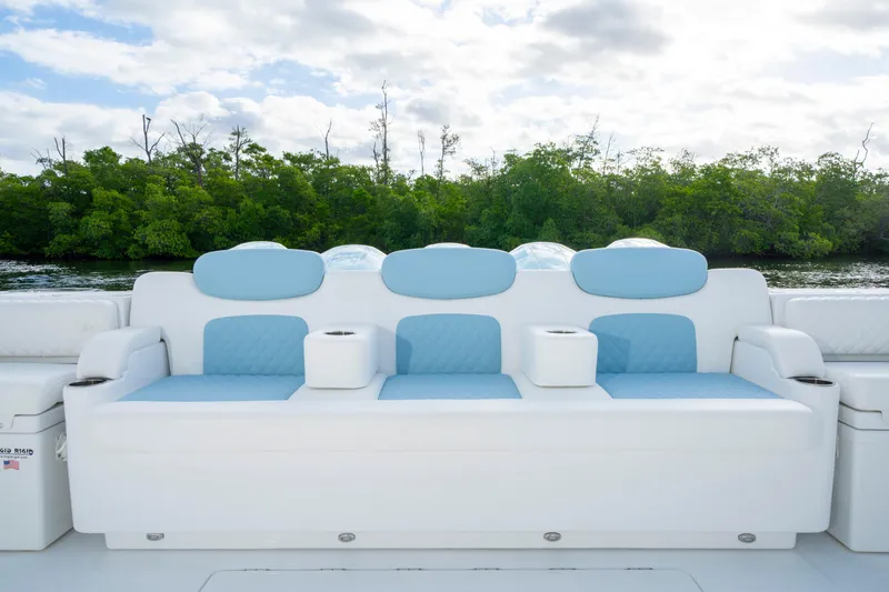  Yacht Photos Pics Luxury seating on 2026 HCB 56 Suenos GIX yacht, with scenic water and greenery backdrop.