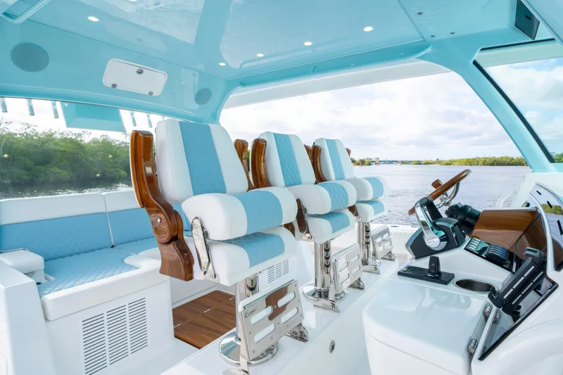  Yacht Photos Pics Luxury interior of 2026 HCB 56 Suenos GIX boat with blue and white seating.