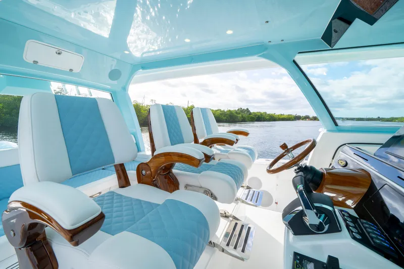  Yacht Photos Pics Luxurious interior of 2026 HCB 56 Suenos GIX yacht with elegant seating and steering wheel.