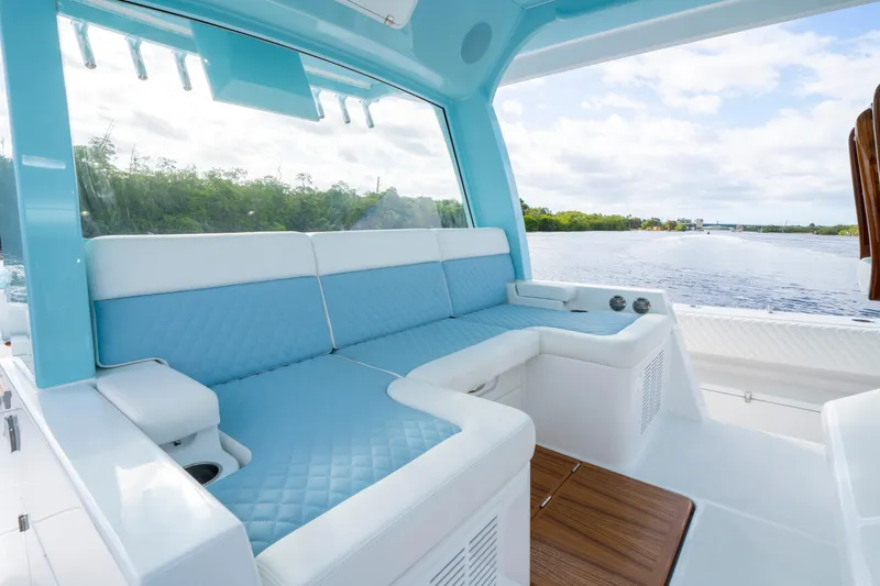  Yacht Photos Pics Luxurious seating area on 2026 HCB 56 Suenos GIX yacht, overlooking serene waterway.