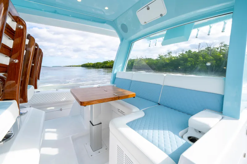  Yacht Photos Pics Luxurious interior of 2026 HCB 56 Suenos GIX yacht with blue seating and wooden table.