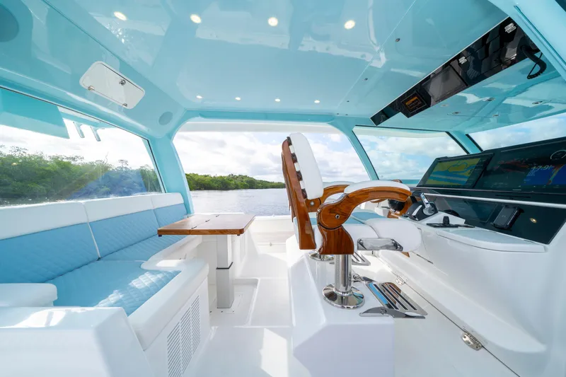  Yacht Photos Pics Luxurious interior of 2026 HCB 56 Suenos GIX yacht with modern helm and seating.
