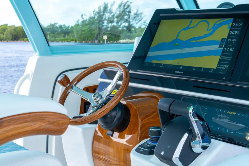  Yacht Photos Pics Helm of 2026 HCB 56 Suenos GIX with Garmin navigation display and wooden steering wheel.