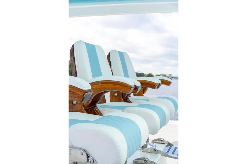  Yacht Photos Pics Luxury seating on 2026 HCB 56 Suenos GIX boat, featuring elegant wood and blue accents.