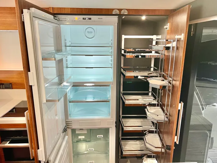  Yacht Photos Pics Modern kitchen with open fridge and pantry in 2020 Maritimo M51 yacht.