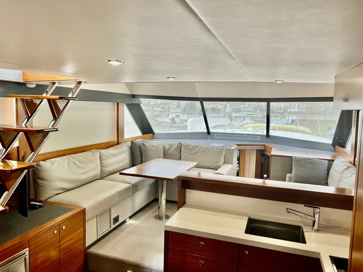  Yacht Photos Pics Luxurious interior of 2020 Maritimo M51 yacht with modern seating and dining area.