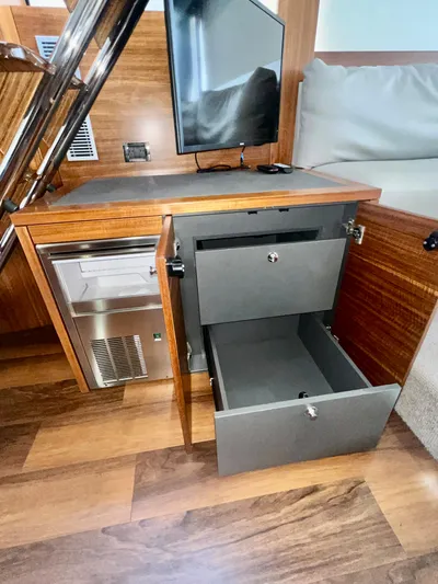  Yacht Photos Pics 2020 Maritimo M51 interior with open storage drawers and a small TV.