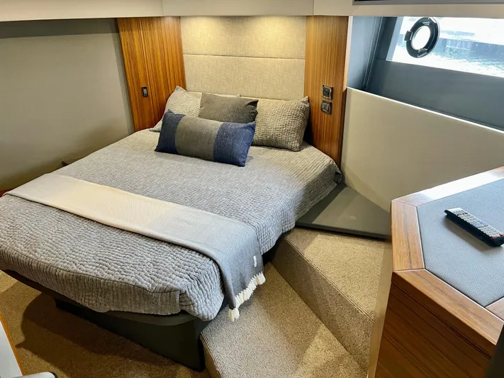  Yacht Photos Pics Luxurious bedroom interior of 2020 Maritimo M51 yacht with modern bedding and wood accents.
