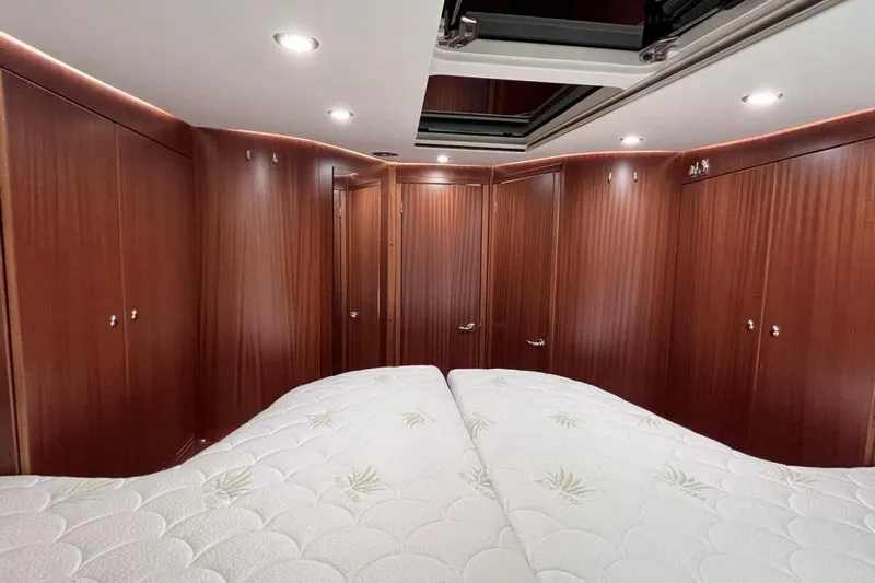  Yacht Photos Pics Luxurious cabin interior of 2023 Nimbus 405 Flybridge yacht with elegant wood paneling.