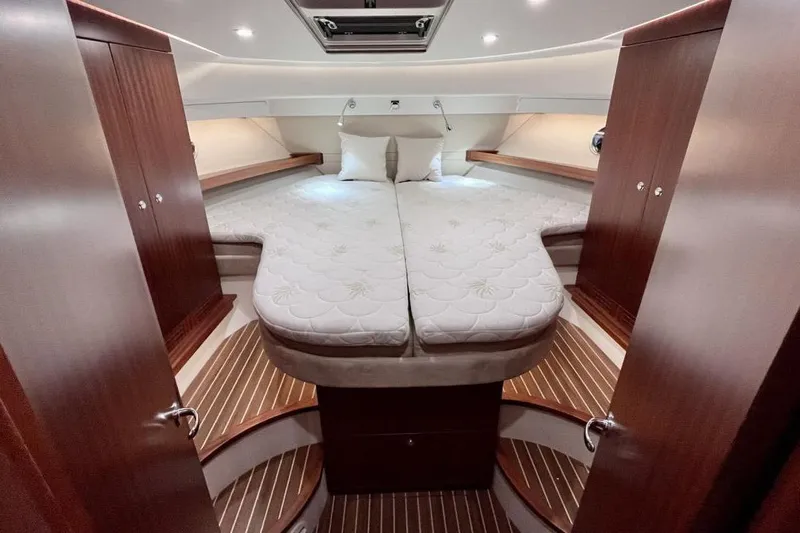  Yacht Photos Pics Luxurious cabin interior of 2023 Nimbus 405 Flybridge yacht with elegant wood finishes.