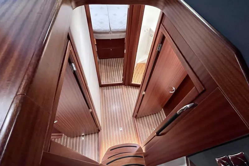  Yacht Photos Pics Luxurious interior of 2023 Nimbus 405 Flybridge yacht with wooden finishes and cozy cabin.