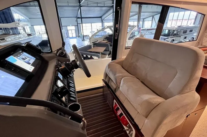  Yacht Photos Pics Interior of 2023 Nimbus 405 Flybridge yacht with helm station and plush seating.