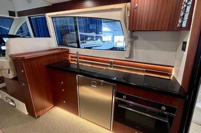  Yacht Photos Pics Luxurious kitchen interior of 2023 Nimbus 405 Flybridge yacht with modern appliances.