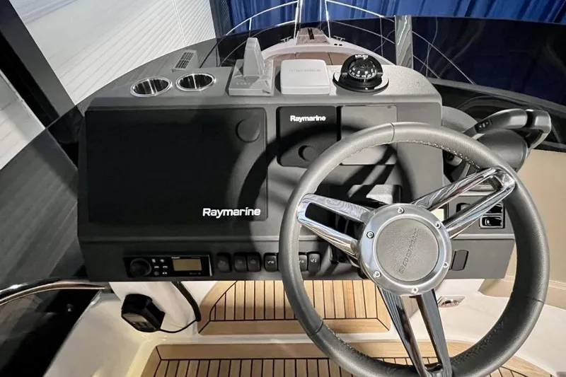  Yacht Photos Pics 2023 Nimbus 405 Flybridge helm with Raymarine electronics and modern steering wheel.