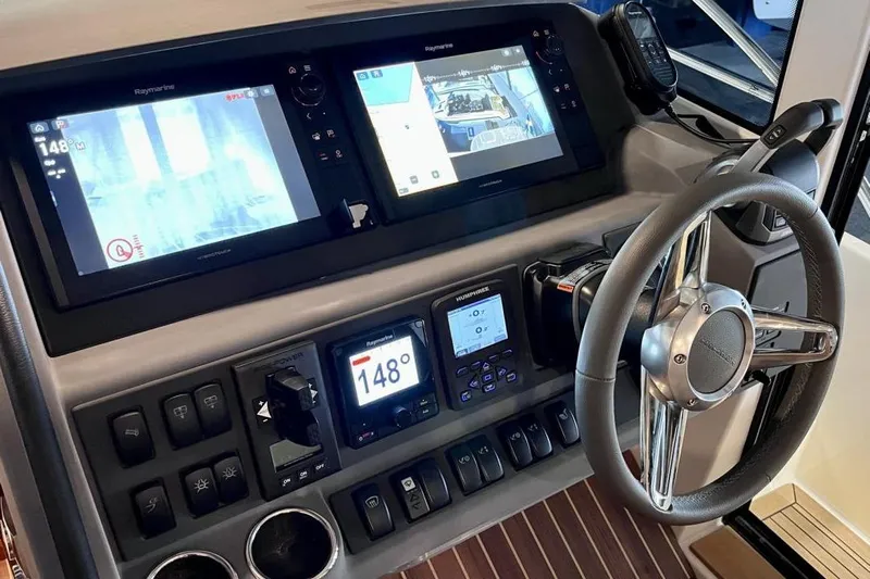  Yacht Photos Pics 2023 Nimbus 405 Flybridge helm with advanced navigation displays and controls.