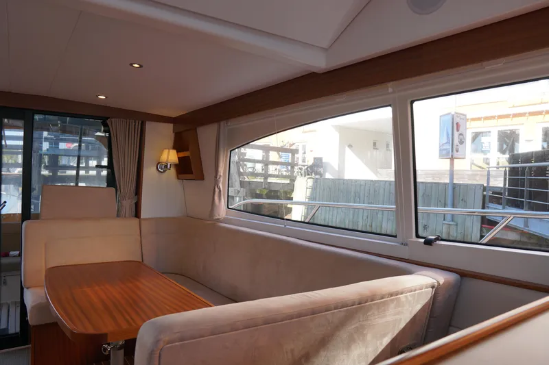  Yacht Photos Pics Luxurious interior of 2023 Nimbus 405 Flybridge yacht with elegant seating.