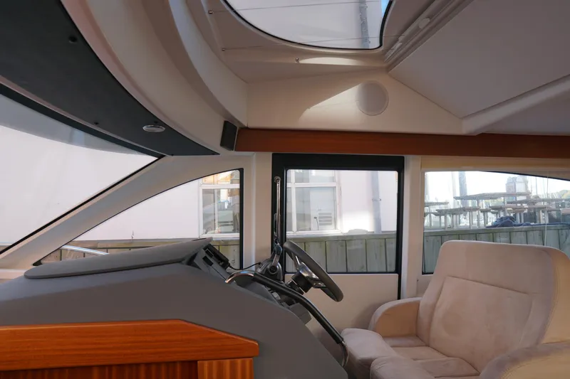  Yacht Photos Pics Interior of 2023 Nimbus 405 Flybridge yacht with helm station and plush seating.