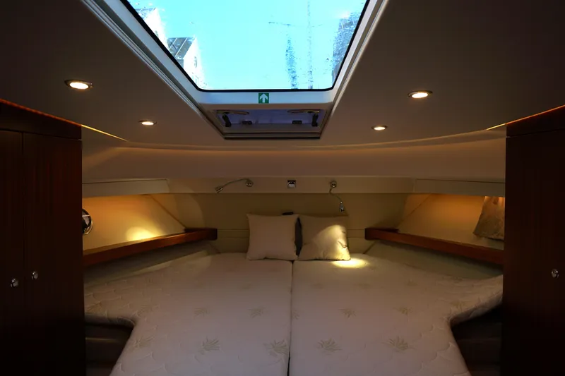  Yacht Photos Pics Luxurious cabin interior of 2023 Nimbus 405 Flybridge yacht with elegant wood finishes.