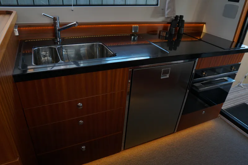  Yacht Photos Pics Luxurious kitchen interior of 2023 Nimbus 405 Flybridge yacht with modern appliances.