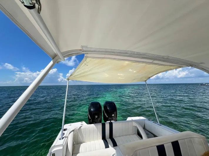 Galore Yacht Photos Pics 2006 Intrepid 323 Cuddy boat with canopy, twin engines, and ocean view.