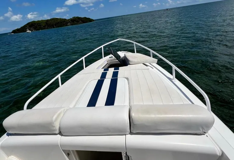Galore Yacht Photos Pics 2006 Intrepid 323 Cuddy boat on open water with island in background.