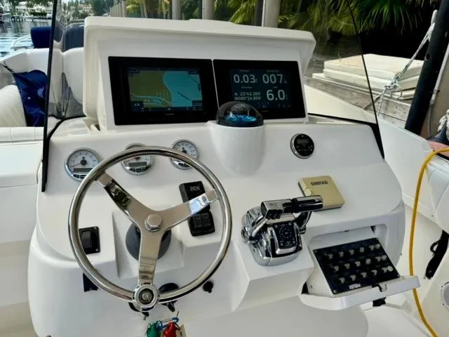 Galore Yacht Photos Pics 2006 Intrepid 323 Cuddy boat dashboard with steering wheel and navigation displays.