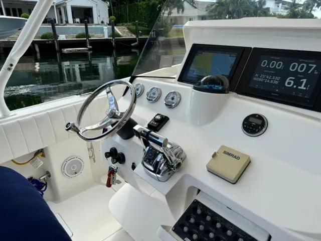 Galore Yacht Photos Pics 2006 Intrepid 323 Cuddy boat dashboard with steering wheel and navigation instruments.