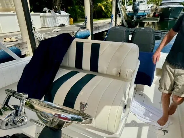 Galore Yacht Photos Pics 2006 Intrepid 323 Cuddy boat interior with striped seating and steering wheel.