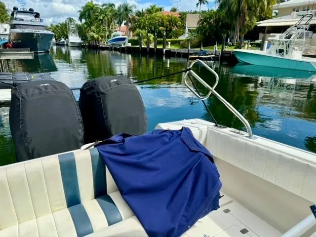 Galore Yacht Photos Pics 2006 Intrepid 323 Cuddy boat docked in a scenic marina with lush greenery.