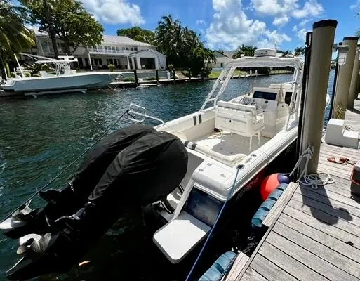 Galore Yacht Photos Pics 2006 Intrepid 323 Cuddy boat docked by a scenic waterfront.