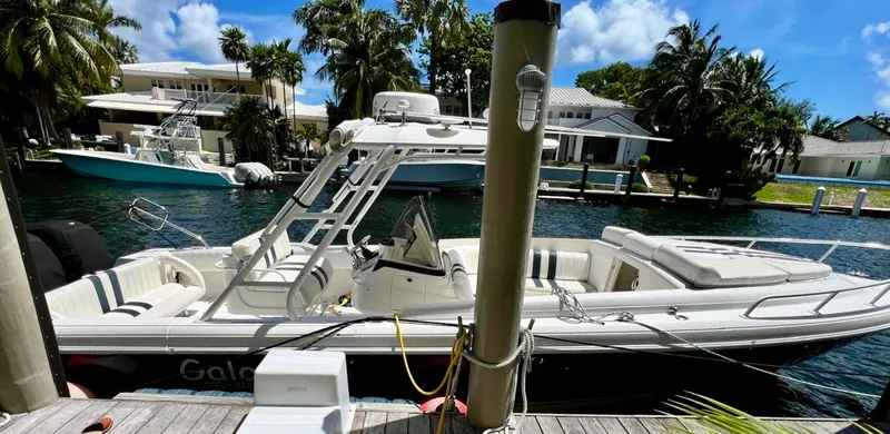 Galore Yacht Photos Pics 2006 Intrepid 323 Cuddy boat docked in a scenic waterfront setting.