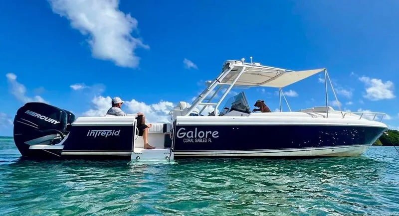 Galore Yacht Photos Pics 2006 Intrepid 323 Cuddy boat on clear water under blue sky.