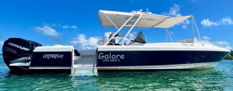 Galore Yacht Photos Pics 2006 Intrepid 323 Cuddy boat on clear water under blue sky.