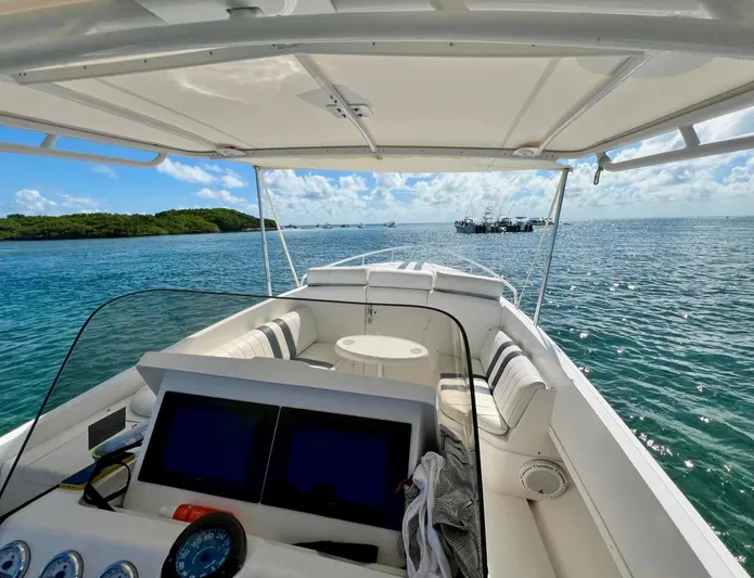 Galore Yacht Photos Pics 2006 Intrepid 323 Cuddy boat on open water, clear sky, and distant islands.